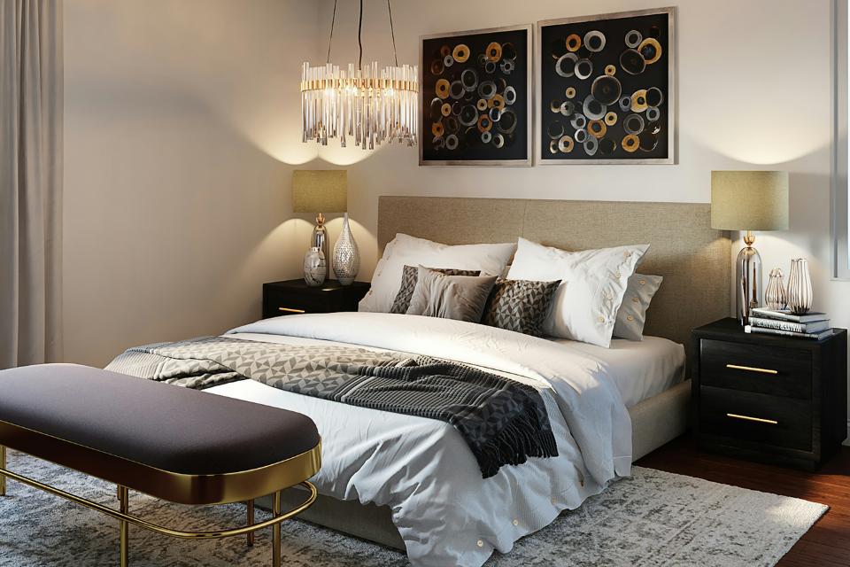 cozy bedroom with wood flooring and grey area rug with black and gold decor.